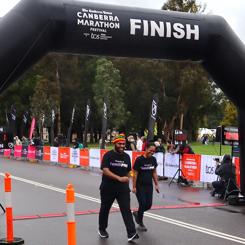 David and Natasha crossing the finish line at the 2023 Canberra Times Marathon Festival.