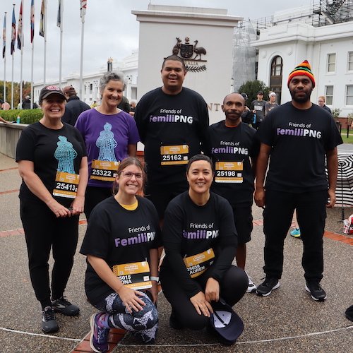 Group photograph of seven #RunforFemiliPNG team members (Fiona, Clare, Moses, Kingtau, David, Fiona and Lauren) in front of Old Parliament House.